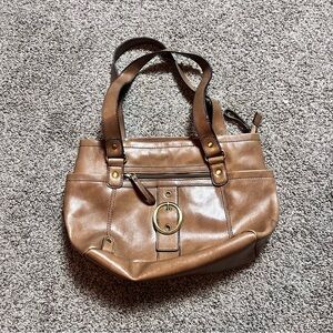 Tan leather handbag with gold accents